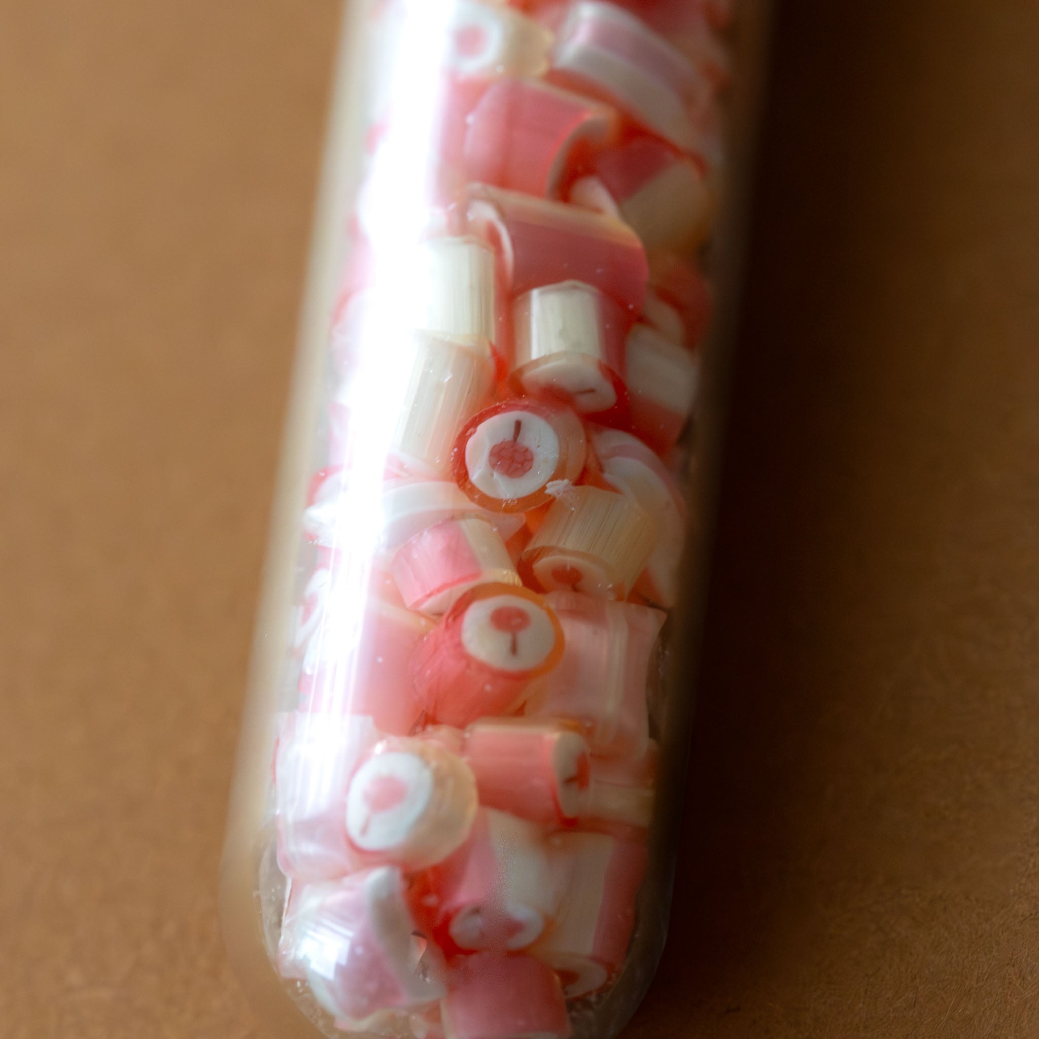 artisanal-hard-candy-tube-lychee-showing-lychee-shape-inside-candy-center