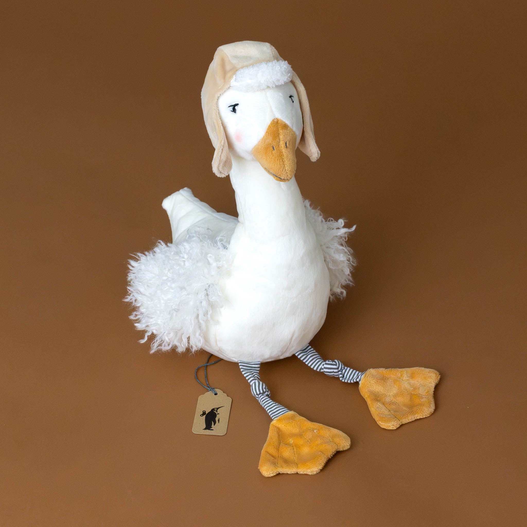 white-avery-aviator-capped-snow-goose-with-fluffy-wings-striped-legs-and-ochre-beak-and-feet