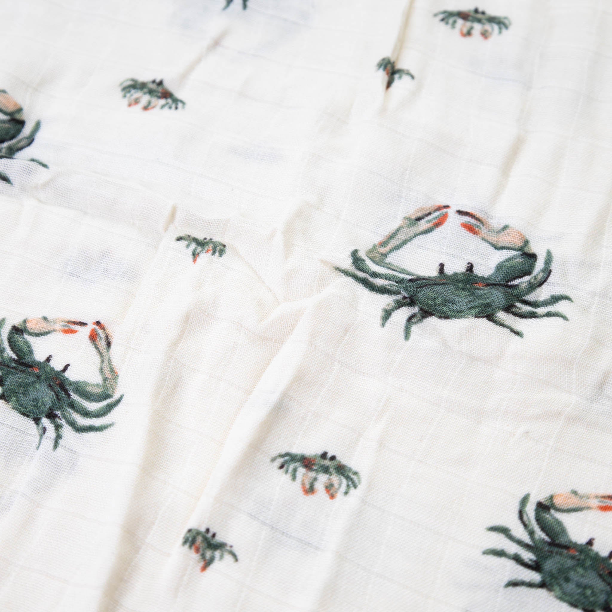 bamboo-swaddle-coastal-crab-green-and-coral-print-on-white-background-detail