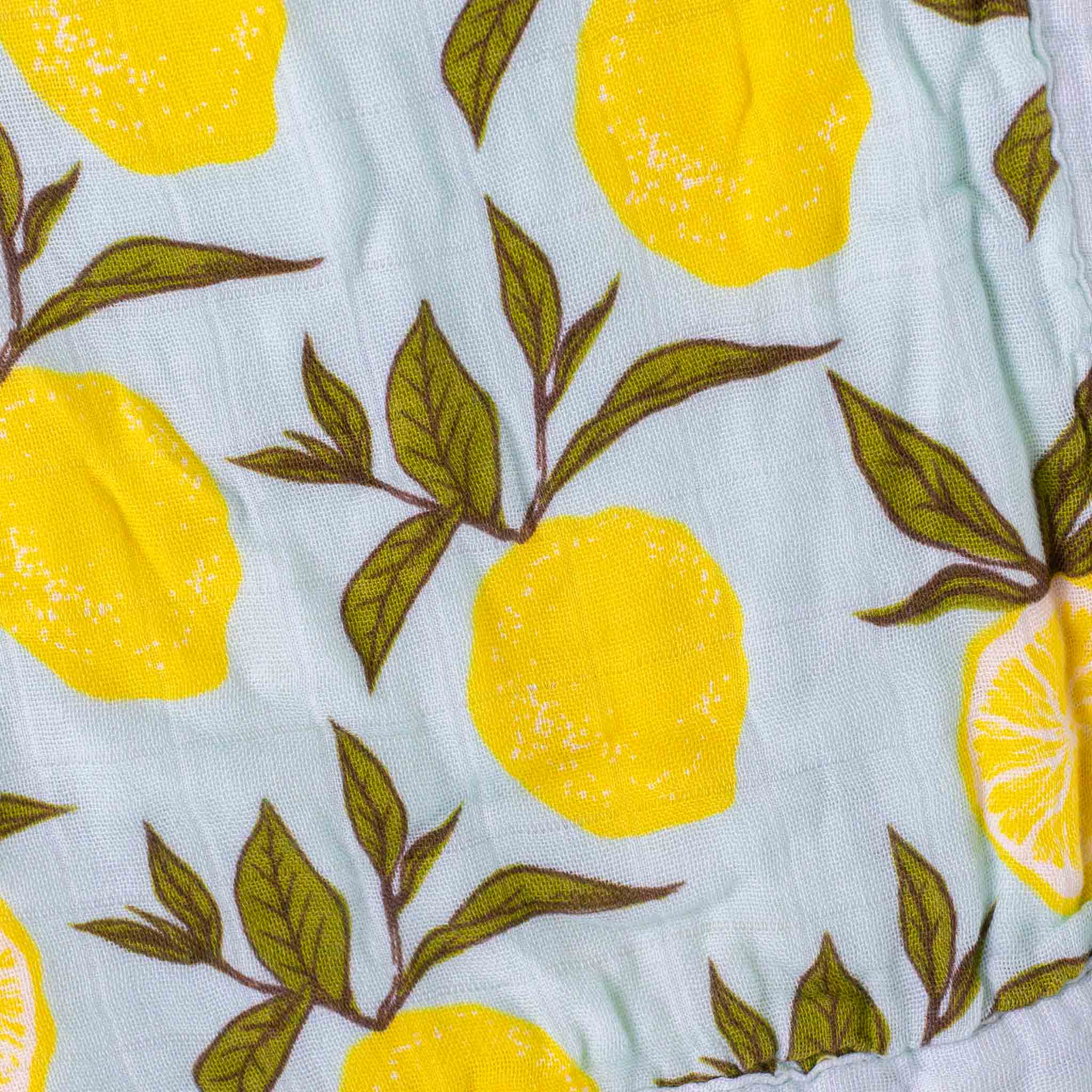 detail-of-pattern-with-yellow-lemons-and-green-leafs-on-a-light-blue-background