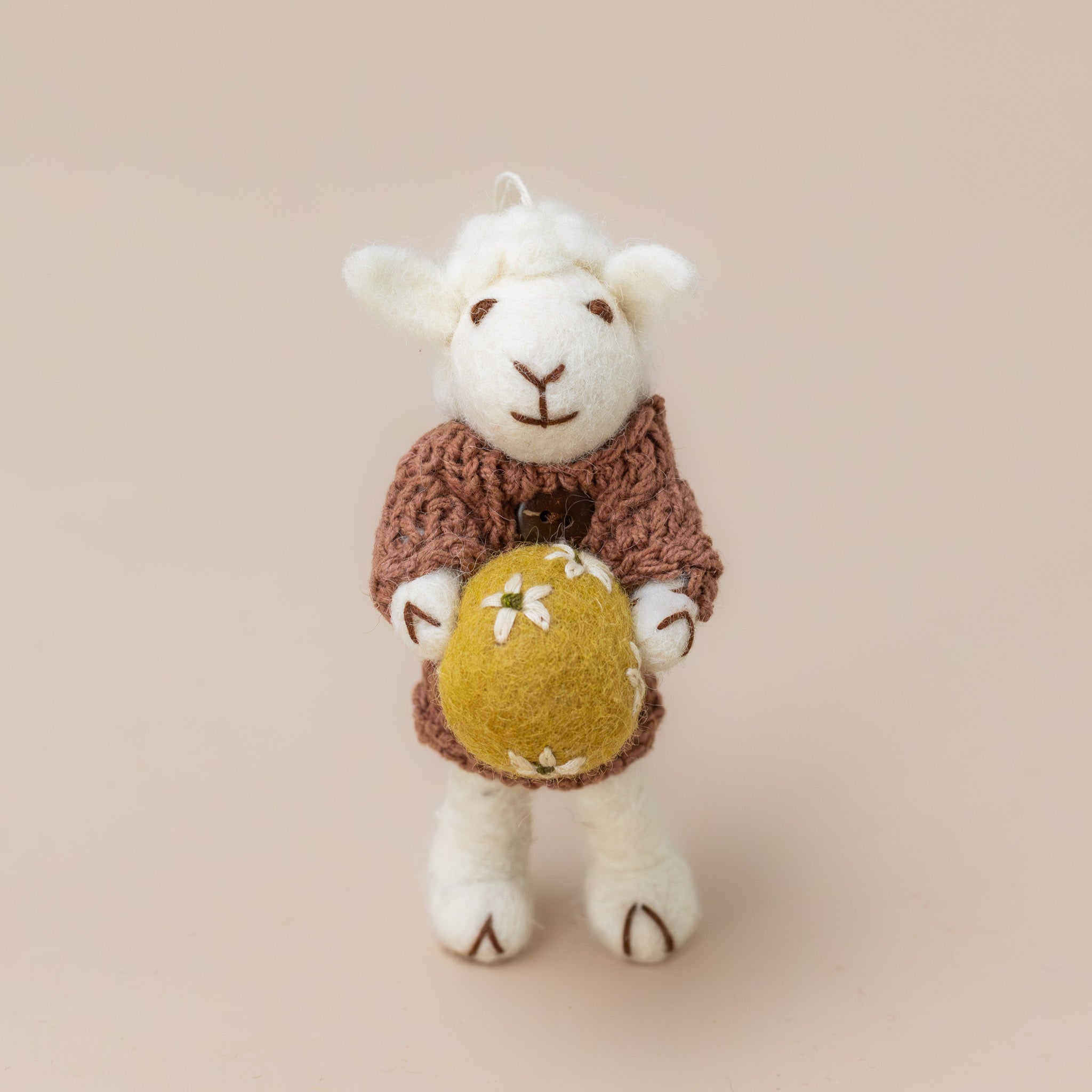 felted-white-sheep-ornament-mauve-dress-with-ochre-egg-standing