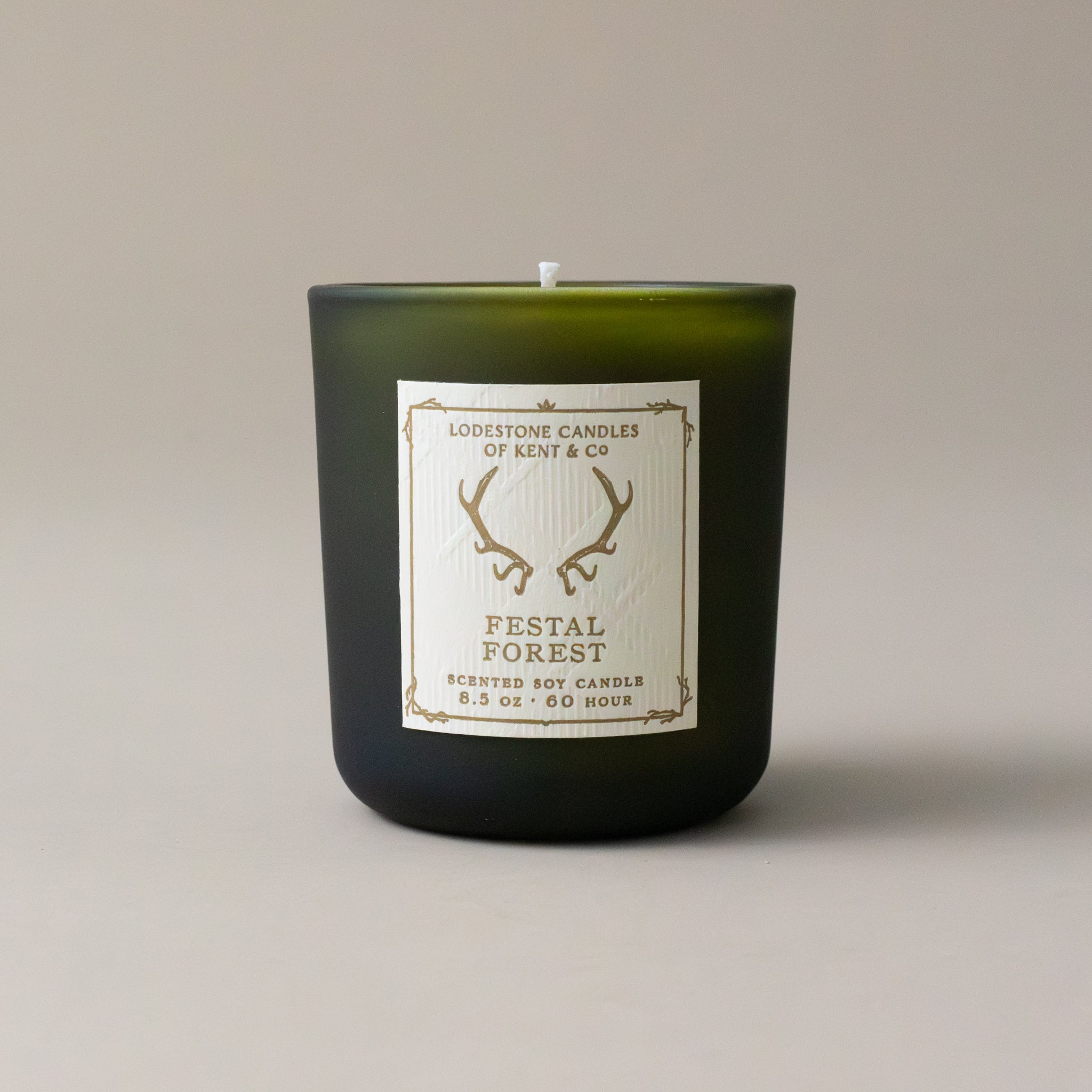 white-soy-festal-forest-candle-in-green-glass-jar