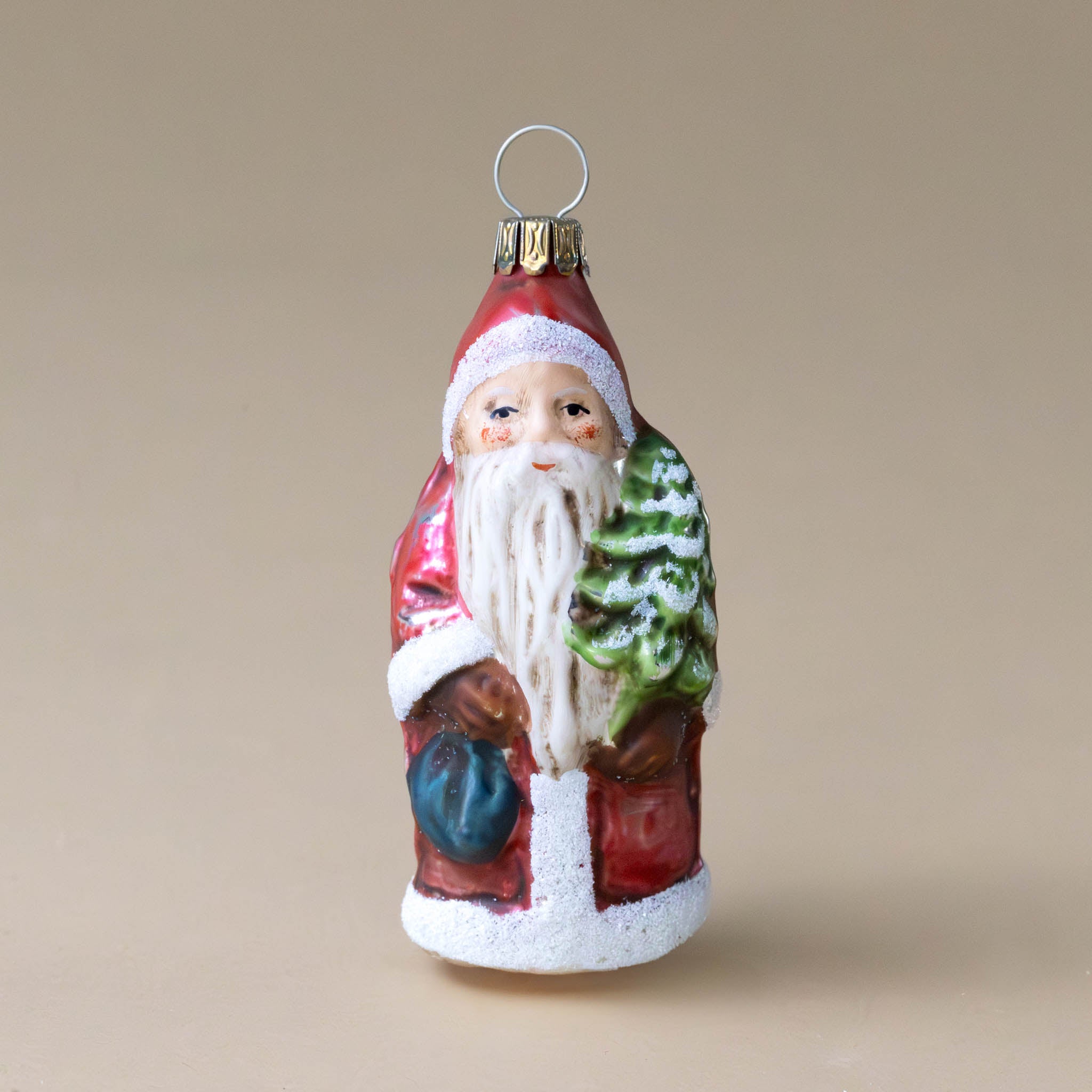 german-glass-ornament-santa-with-backpack-and-tree-front