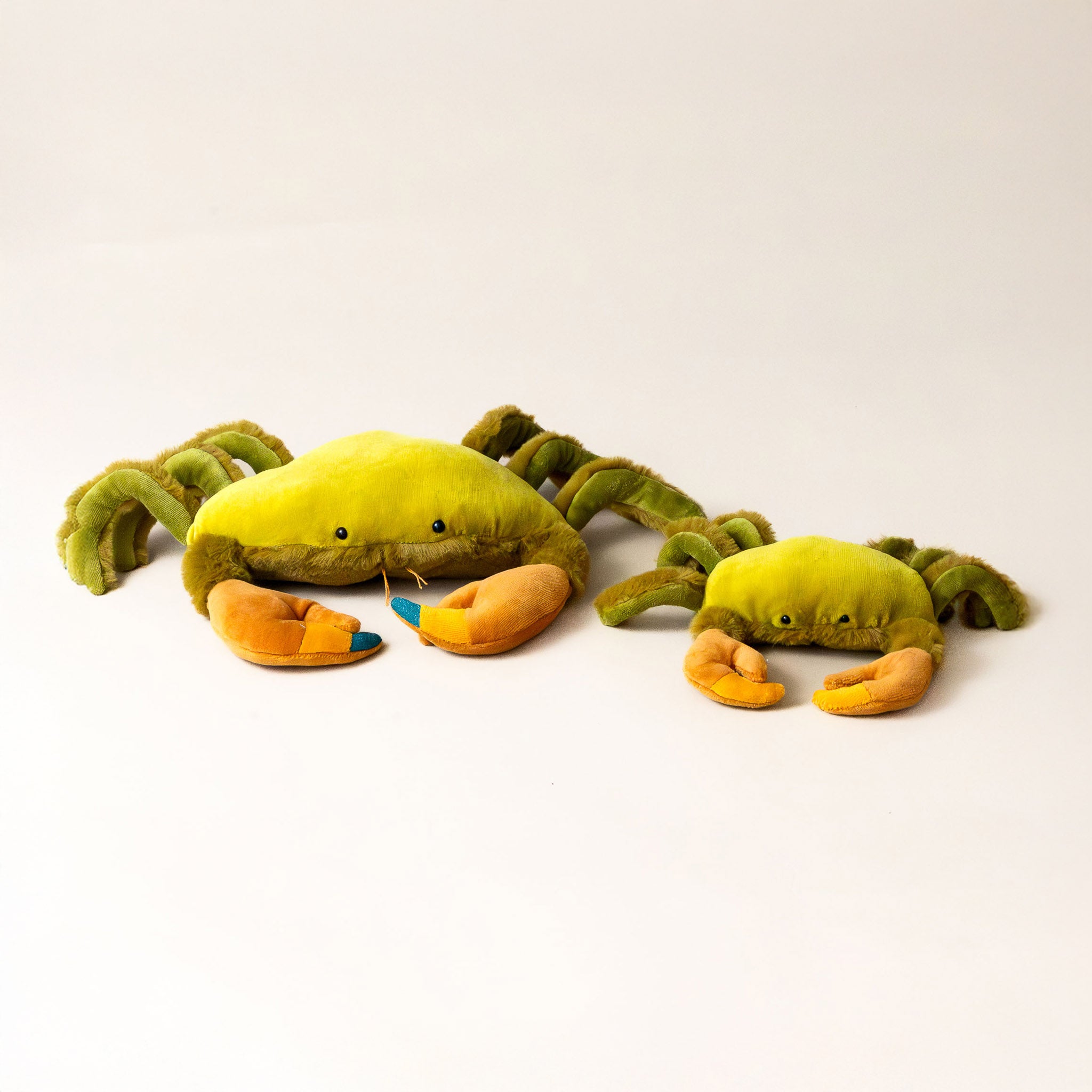 green-crabbie-grande-and-petit-stuffed-animal-with-six-legs-two-orange-claws