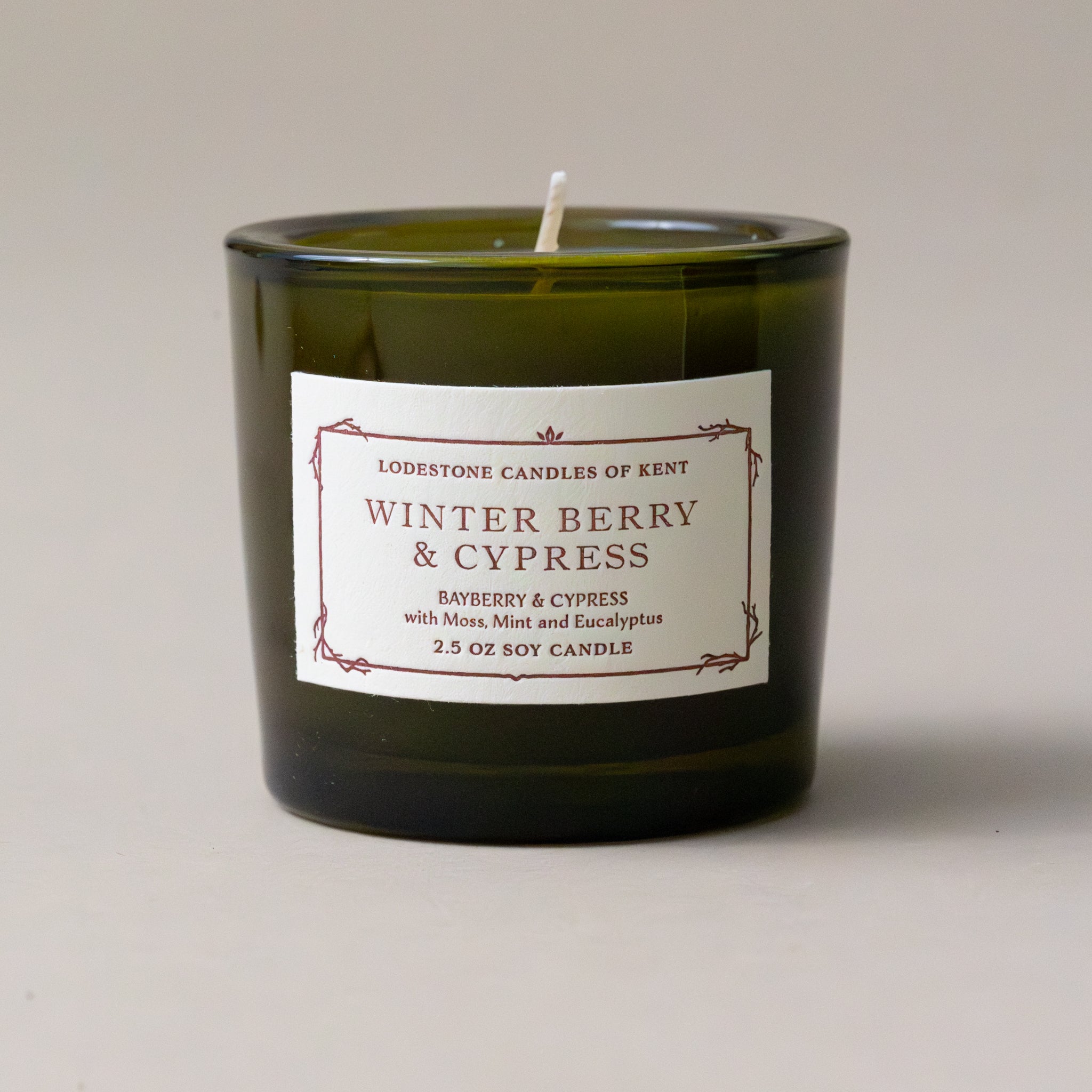 winter-berry-single-candle-from-holiday-candle-gifttrio-in-green-glass-jar-with-white-candle