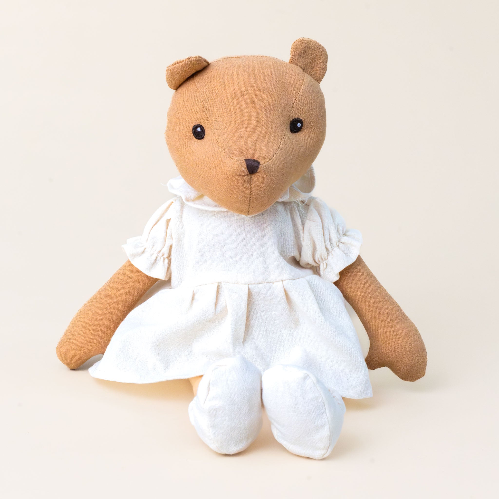 juliette-the-carmel-colored-bear-in-cream-colored-dress-and-shoes-sitting