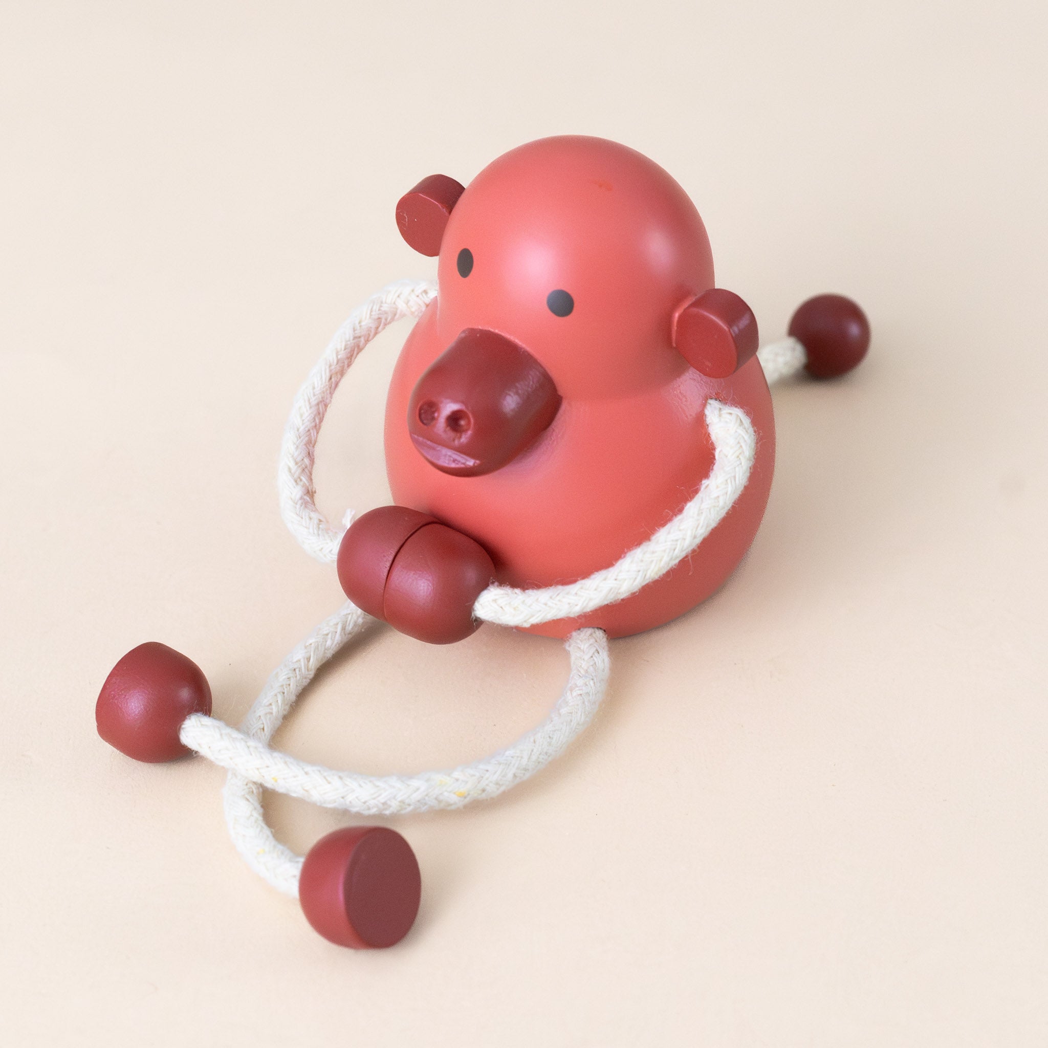 little-palimal-friend-red-wood-monkey-with-corded-arms-sitting-with-legs-crossed-and-arms-connected