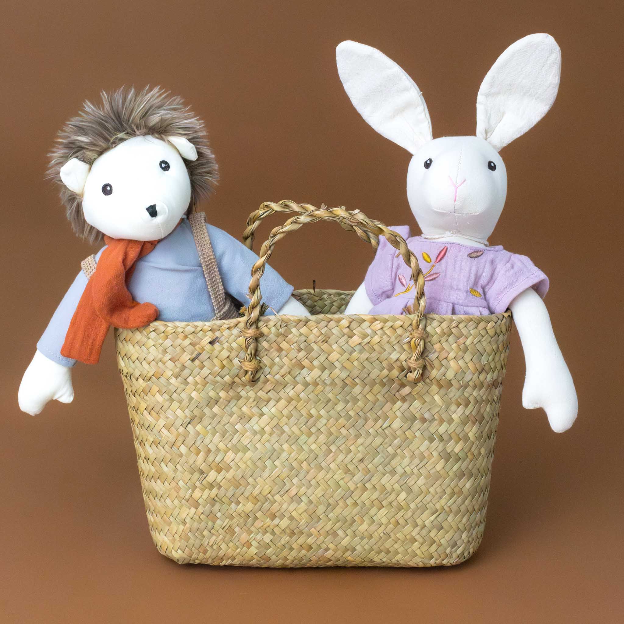 natural-woven-straw-tote-holding-two-stuffed-animials