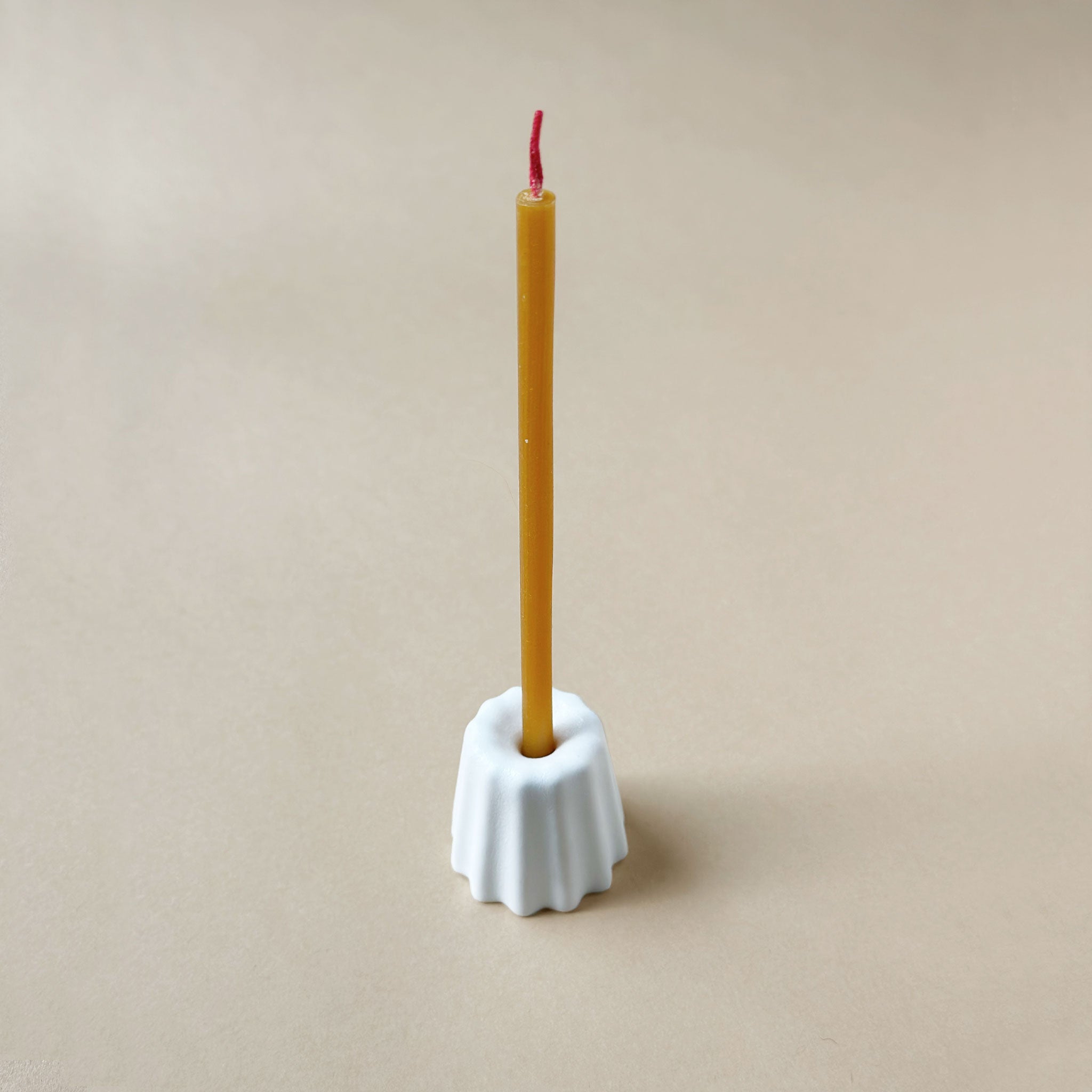 slim-candle-inside-porcelain-holder