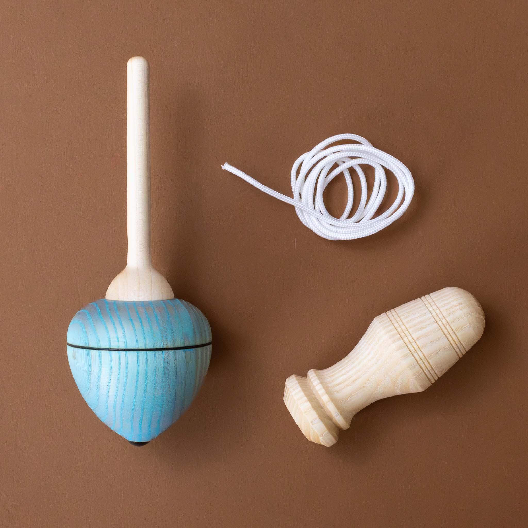 pull-string-wooden-spinning-top-with-blue-base-pulled-into-functional-pieces