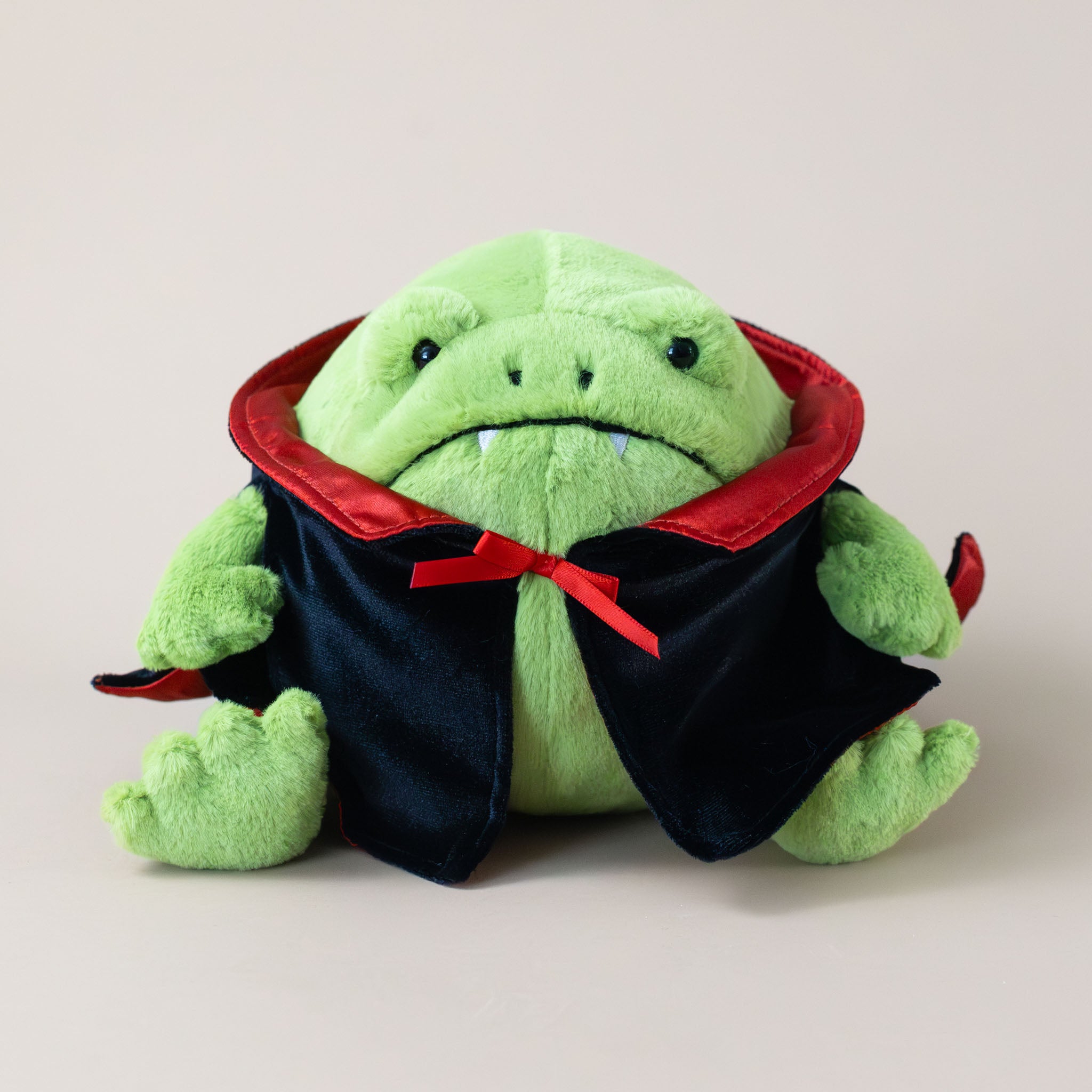 ricky-rain-frog-in-black-and-red-vampire-cape-and-fangs-stuffed-animal