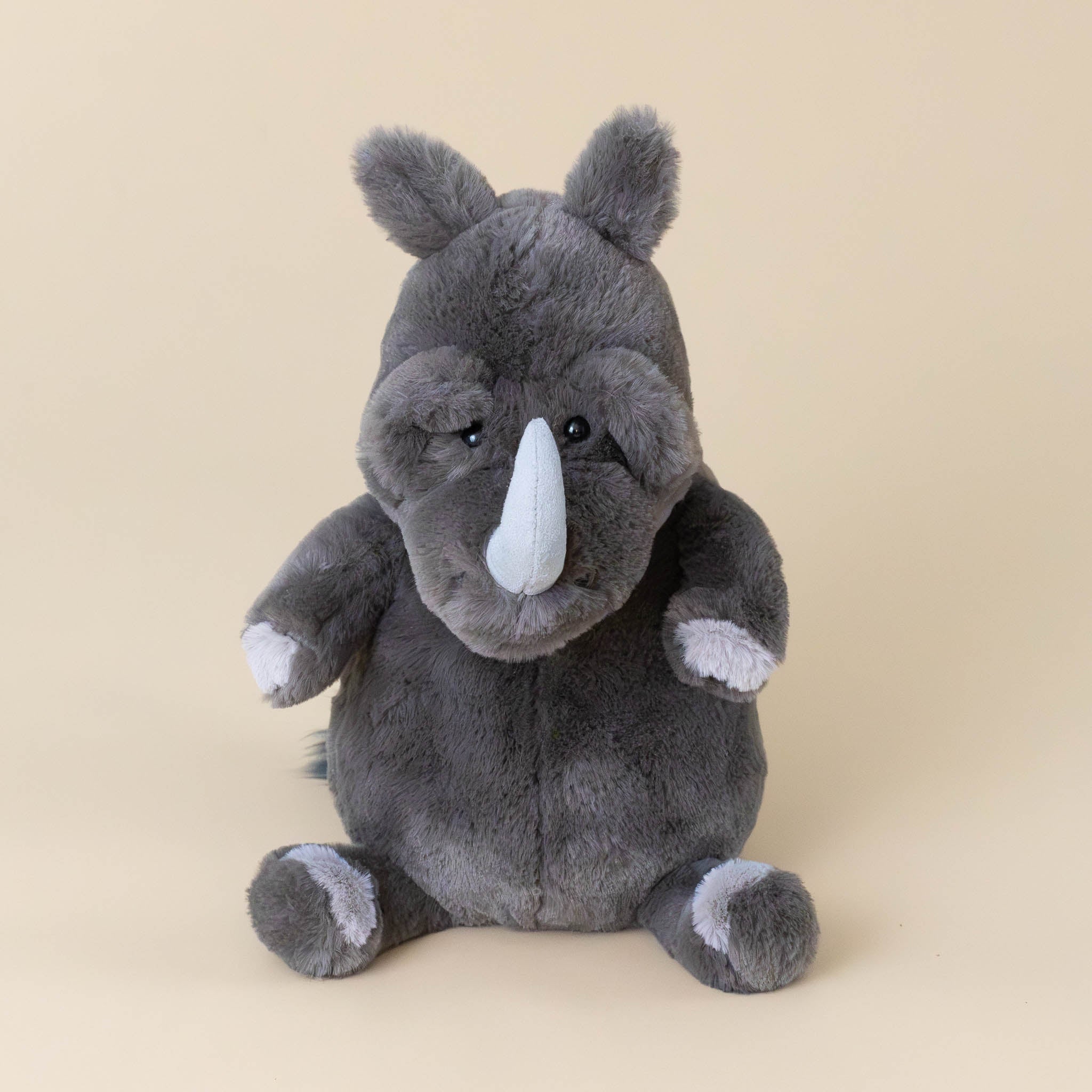 roderick-rhinoceros-grey-stuffed-animial-with-light-grey-horn-hooves-and-fluffy-tail-front