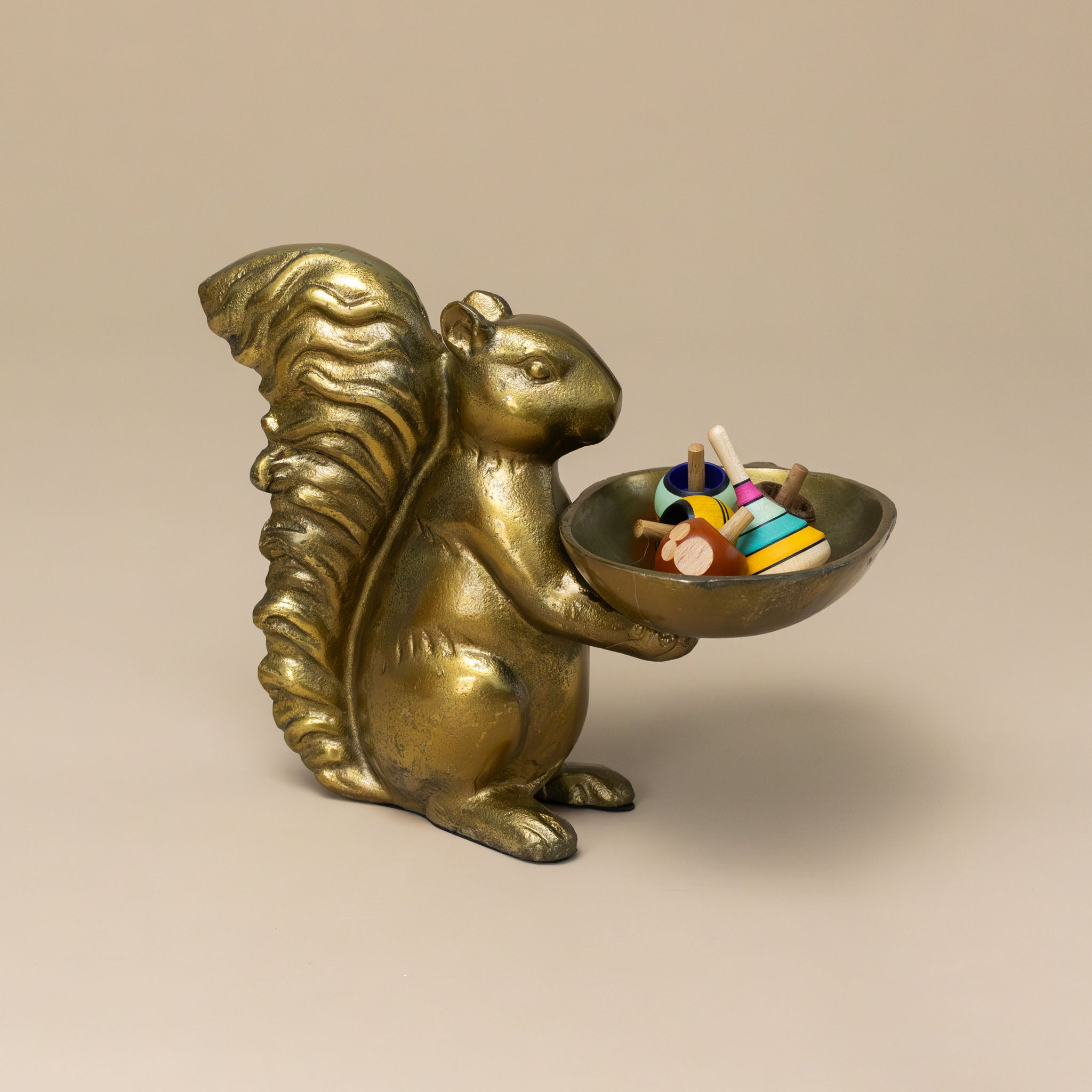 squirrel-brass-dish-stand-holding-colorful-tops