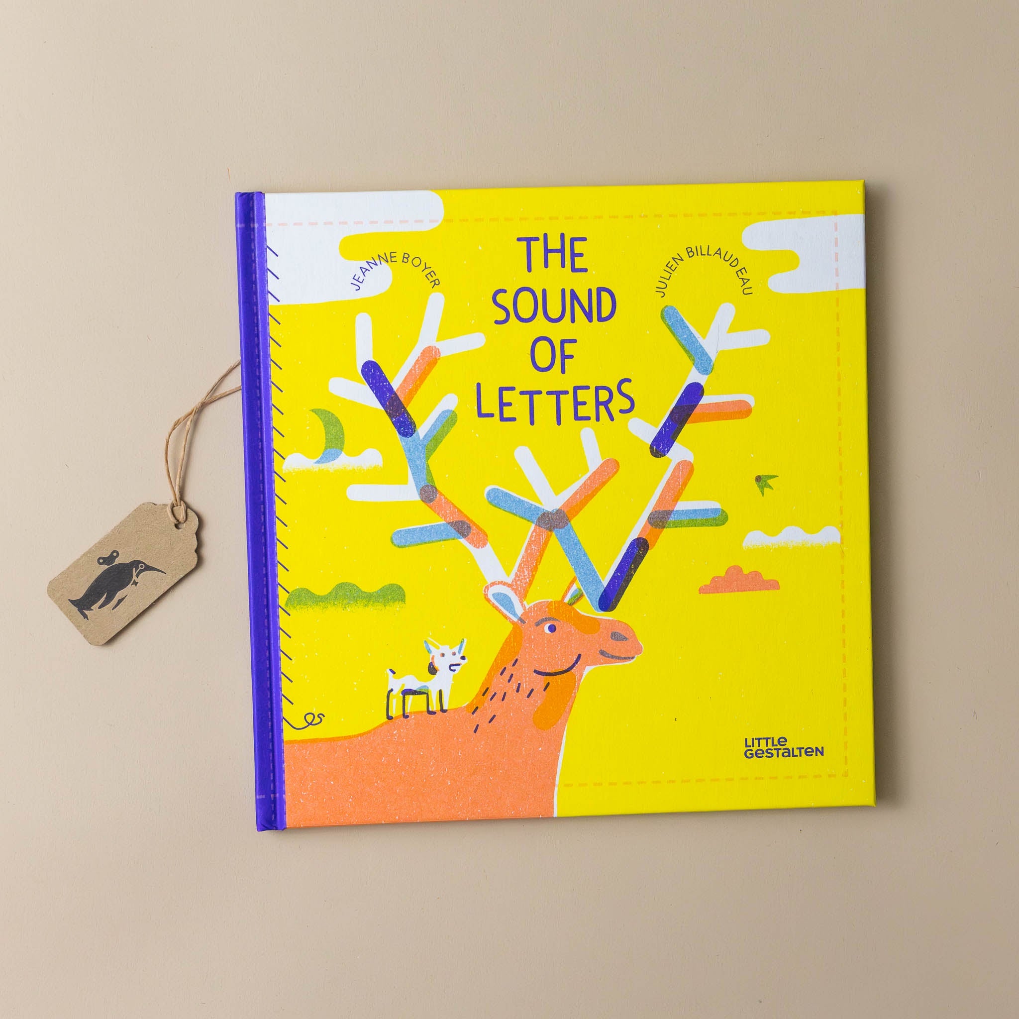 the-sound-of-letters-yellow-cover-with-a-deer-and-antlers-with-a-puppy-on-its-back