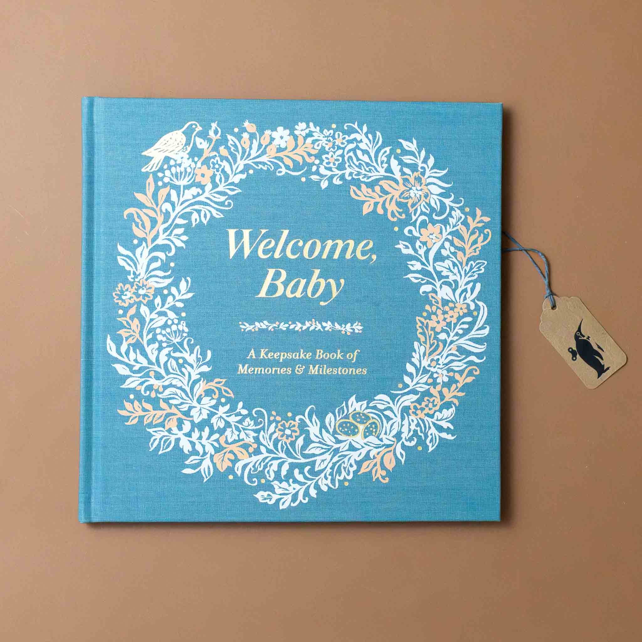 welcome-baby-book-with-floral-wreath-and-green-cloth-cover-with-gold-foil-text