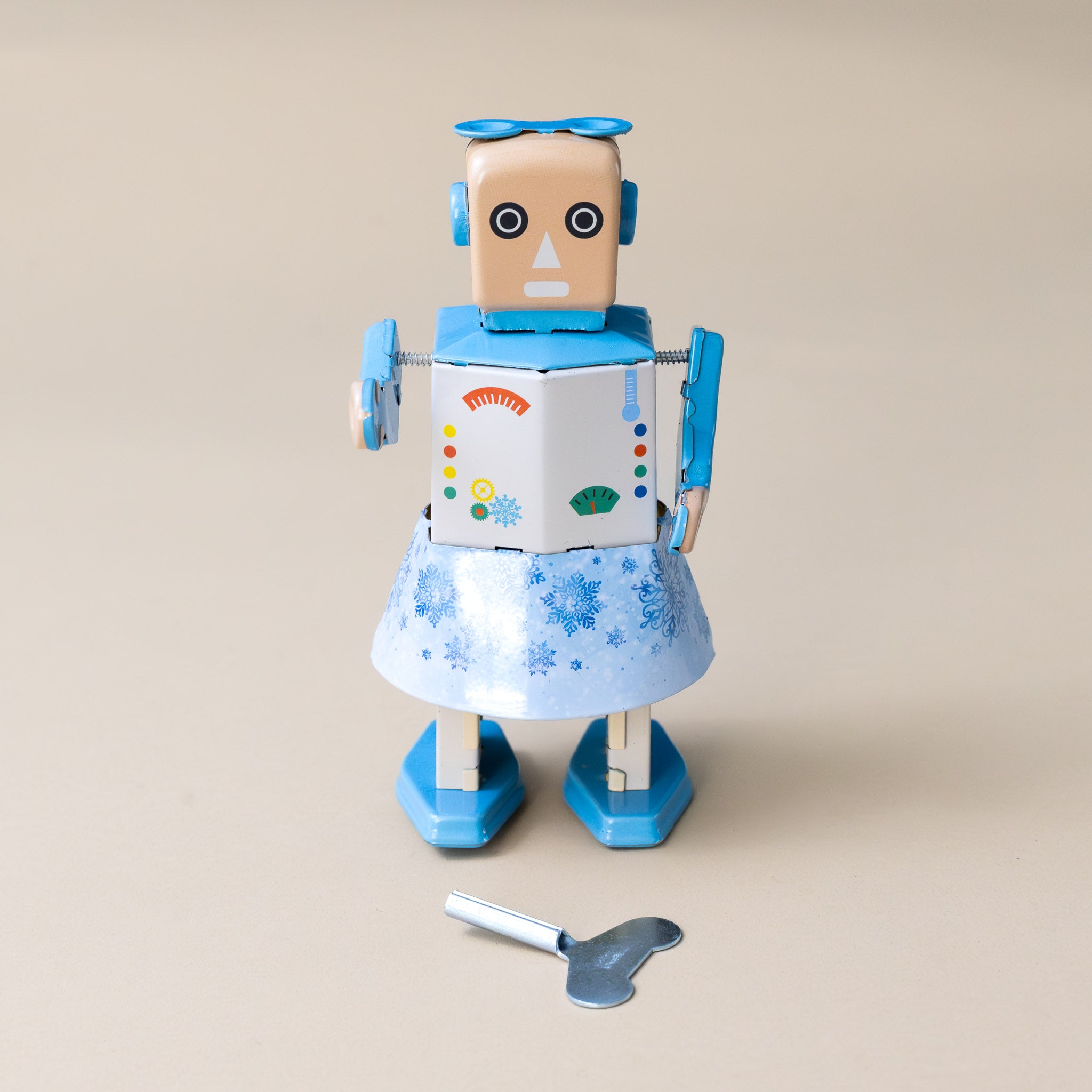 wind-up-tin-snowbot-blue dress-shoes-and-bow-with-snowflake-details-and-wind-up-key