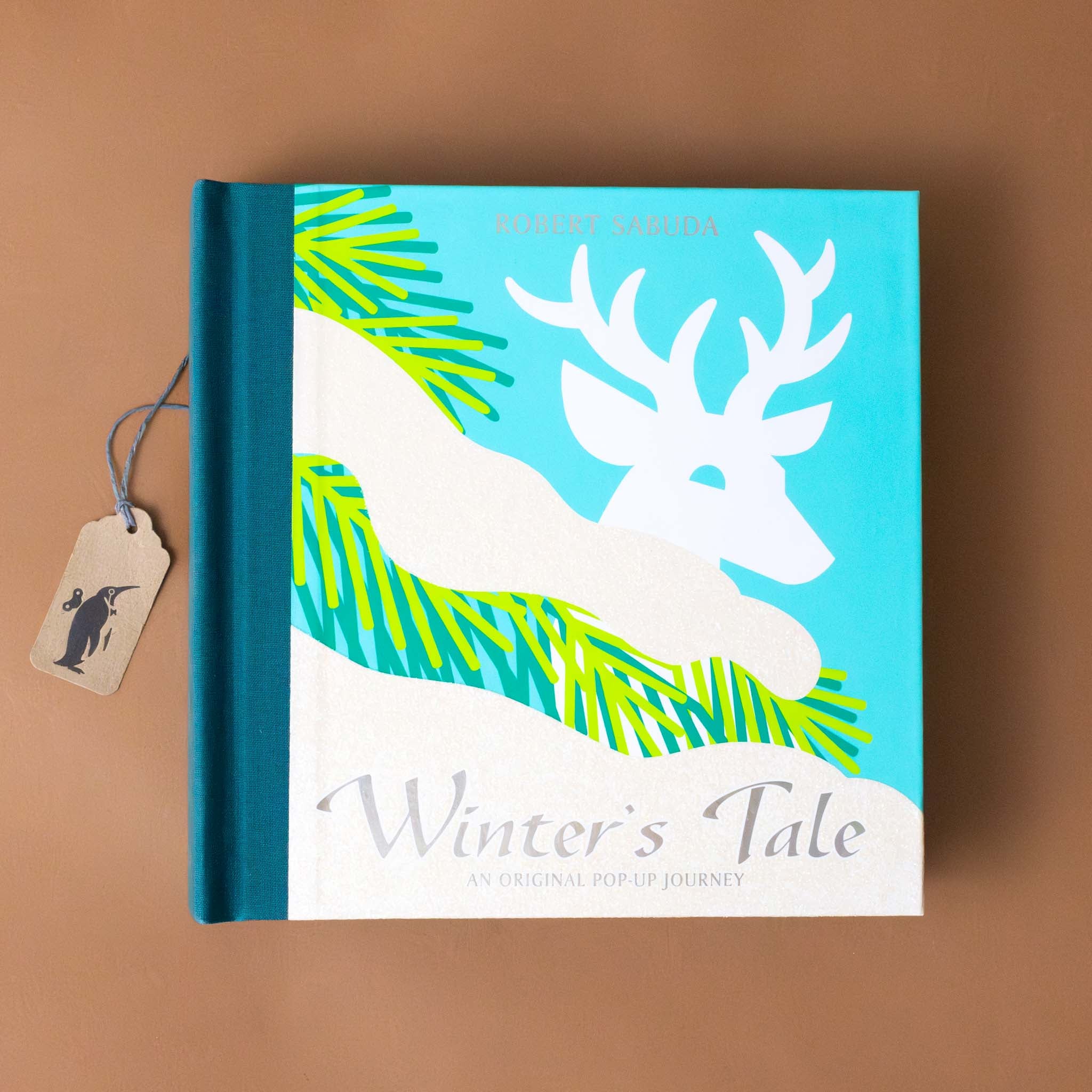 winters-tale-an-original-pop-up-journey-cover-with-a-stag-in-a-winter-scene