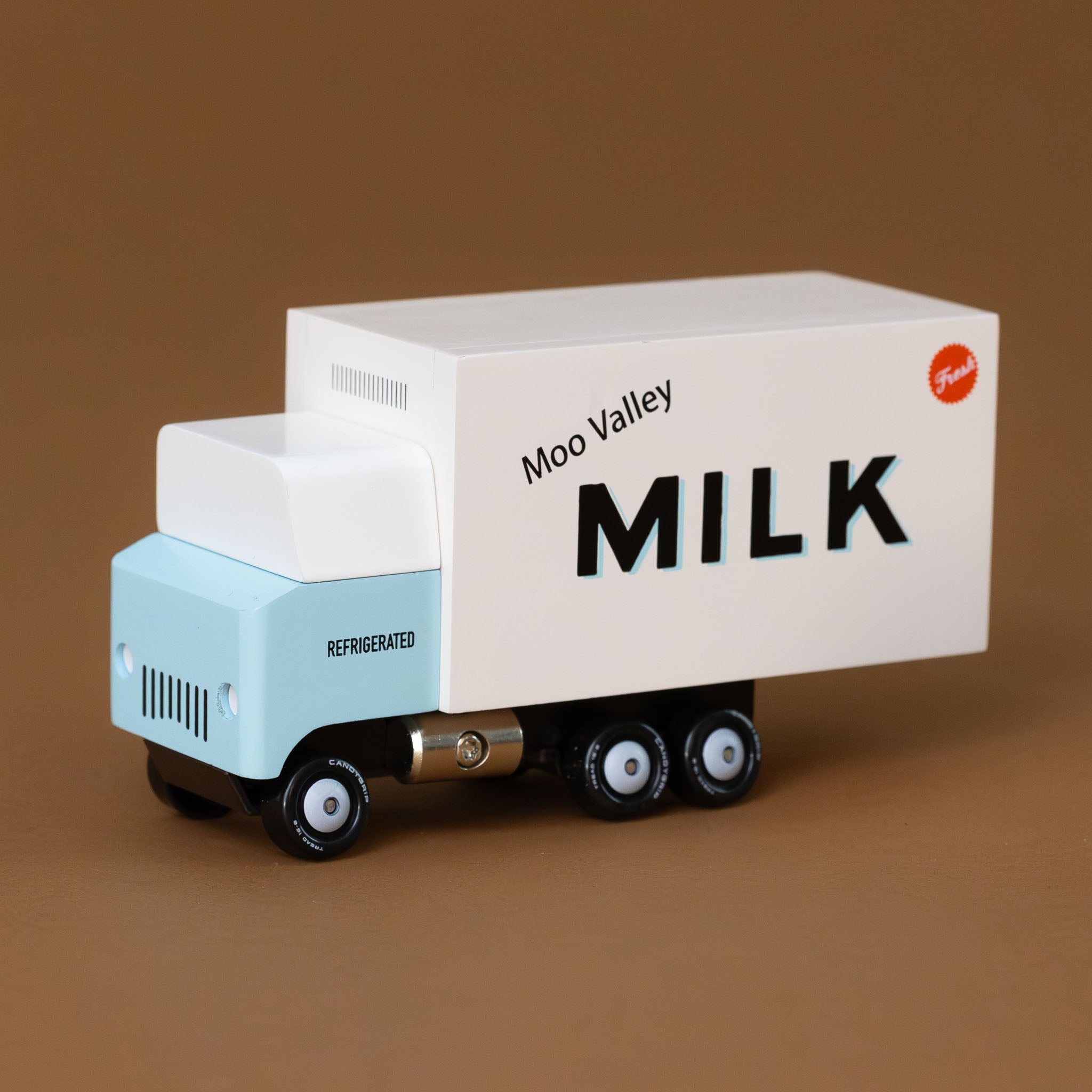 baby-blue-and-white-wooden-candyvan-milk-delivery-truck-with-Moo-Valley-Milk-on-the-side-with-a-red-fresh-emblem