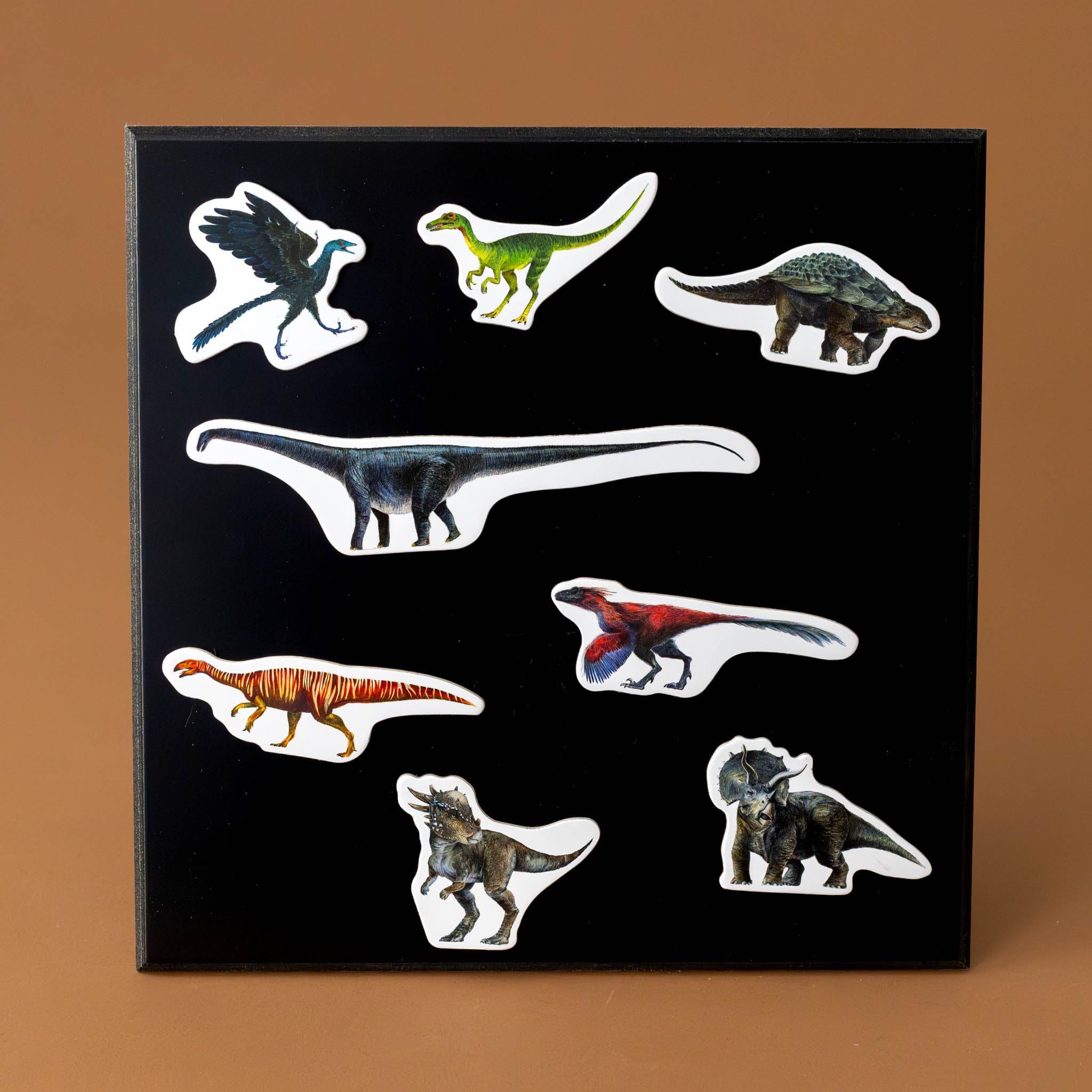 wooden-magnet-set-dinosaurs-shown-atop-magnetic-black-board-sold-separately