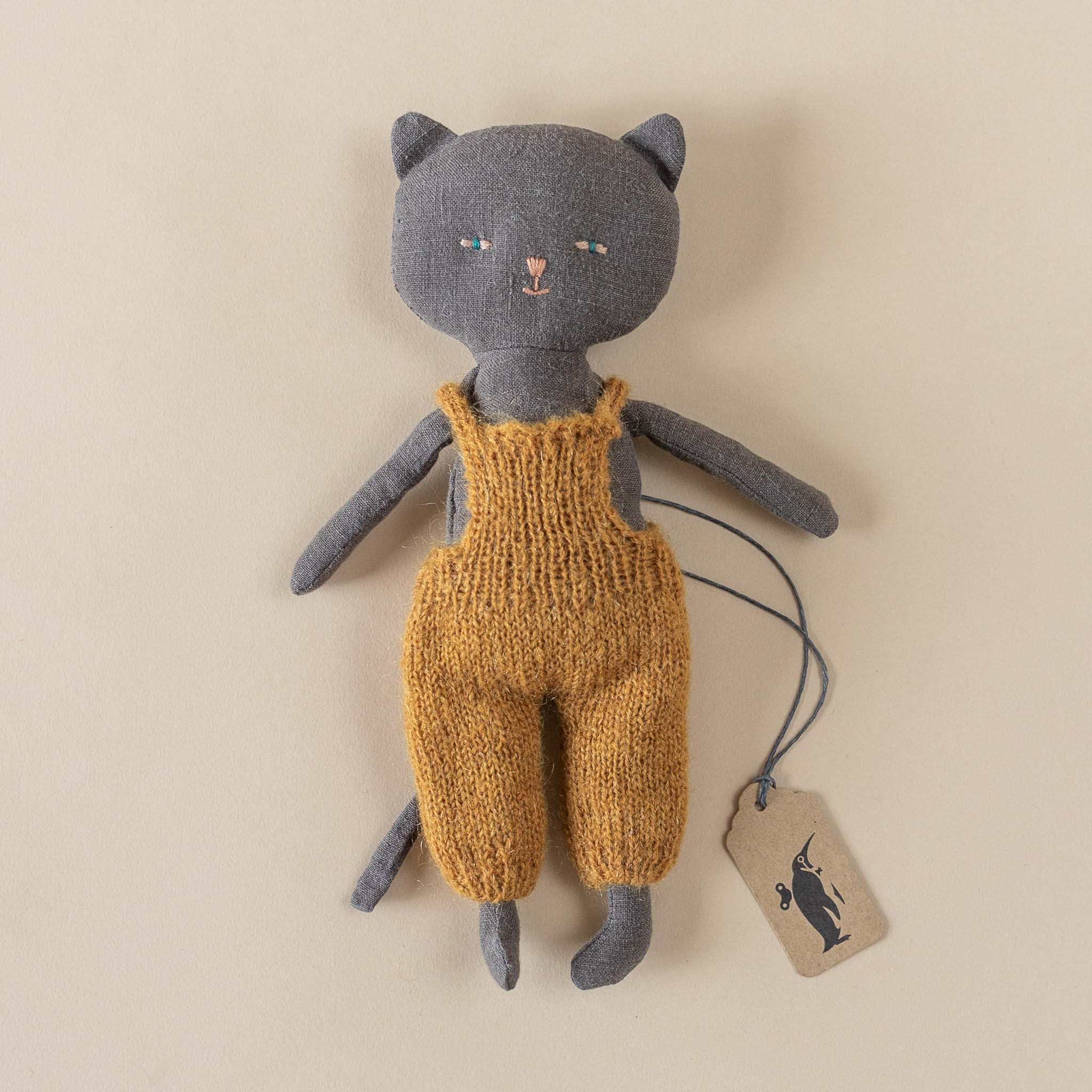 black-linen-kitten-stuffed-animal-in-ochre-knit-overalls