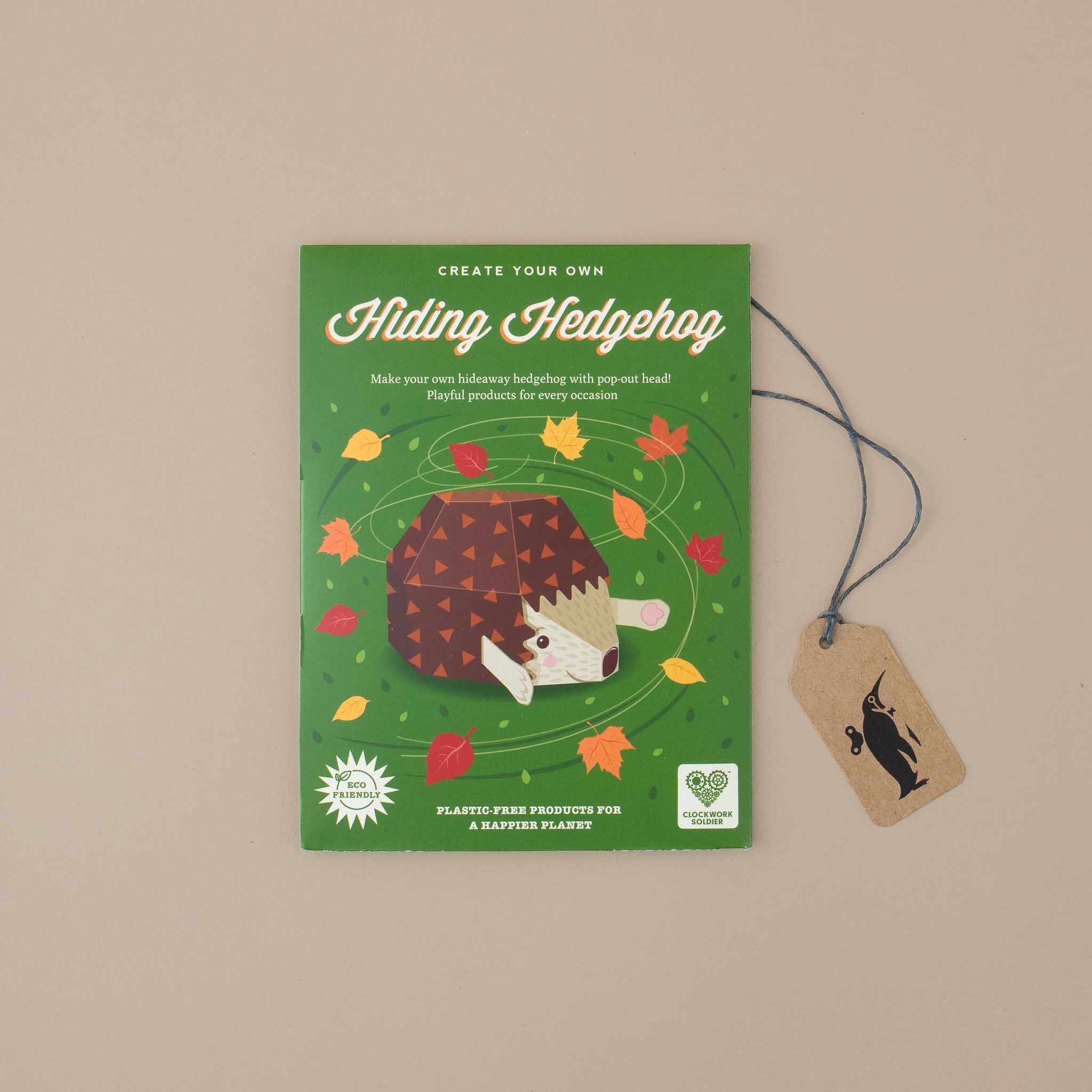 green-flat-package-showing-a-paper-build-hedgehog-and=colorful-leaves