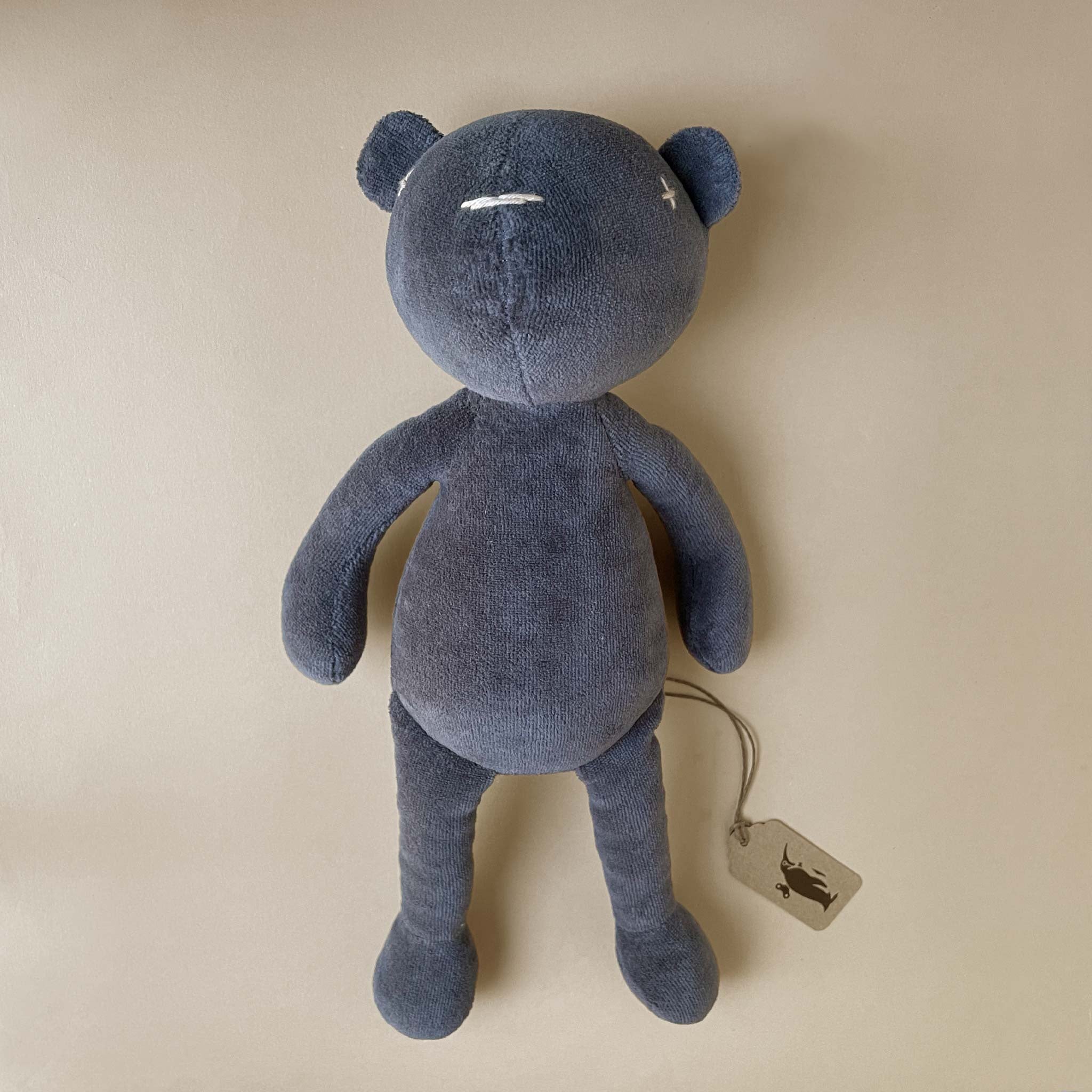 dark-grey-bear-with-stitched-details-laying-down