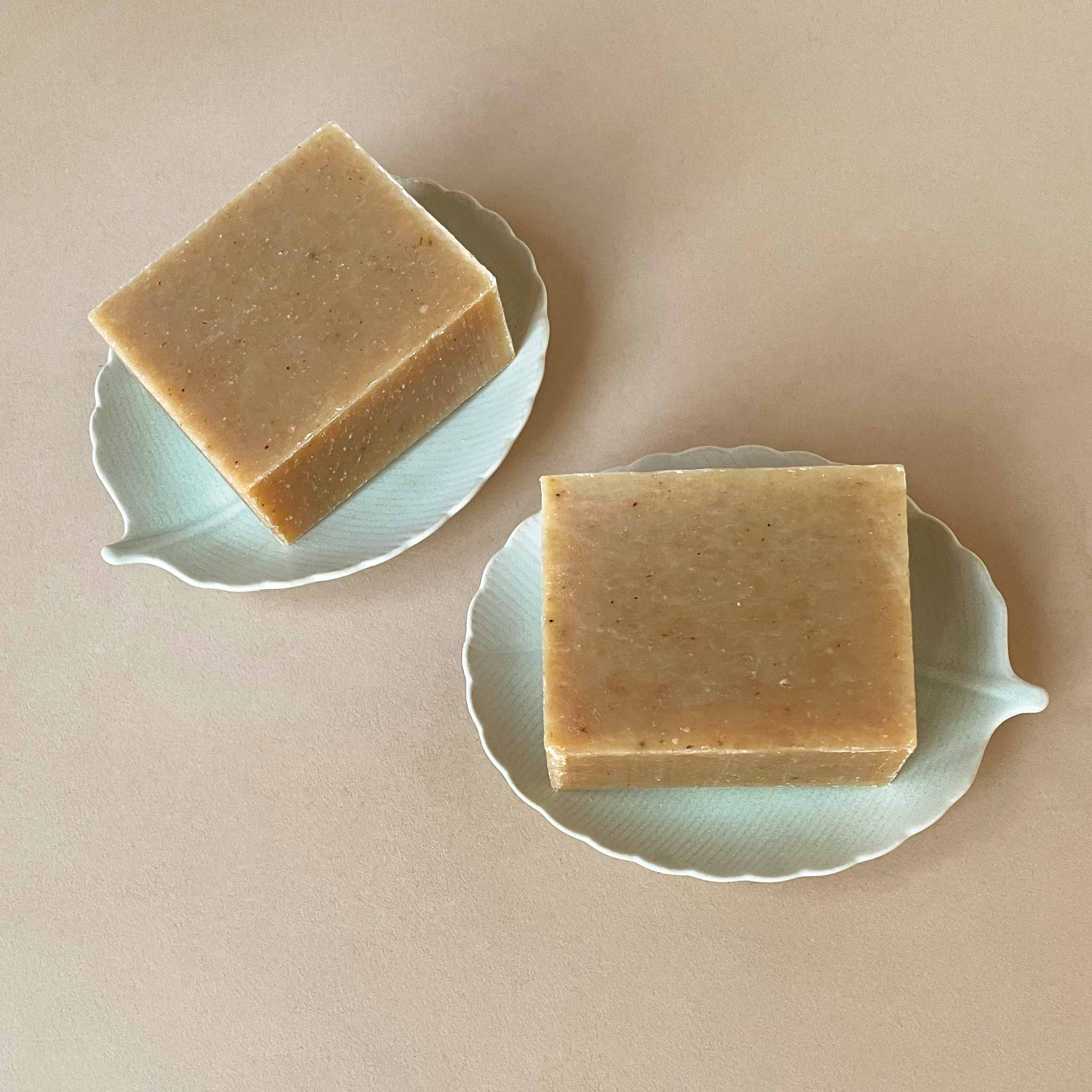 two-bars-of-lavender-honey-soap-on-leaf-soap-dishes